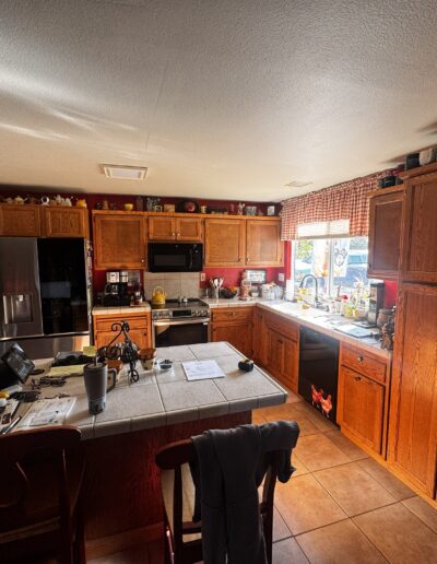 Original kitchen in Shingle Springs, CA with oak cabinets, tile countertops, center island and ceramic tile flooring before complete remodeling