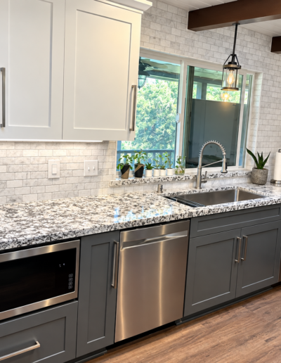 Completed kitchen remodel featuring gray shaker cabinets, granite countertops, stainless steel appliances and marble backsplash